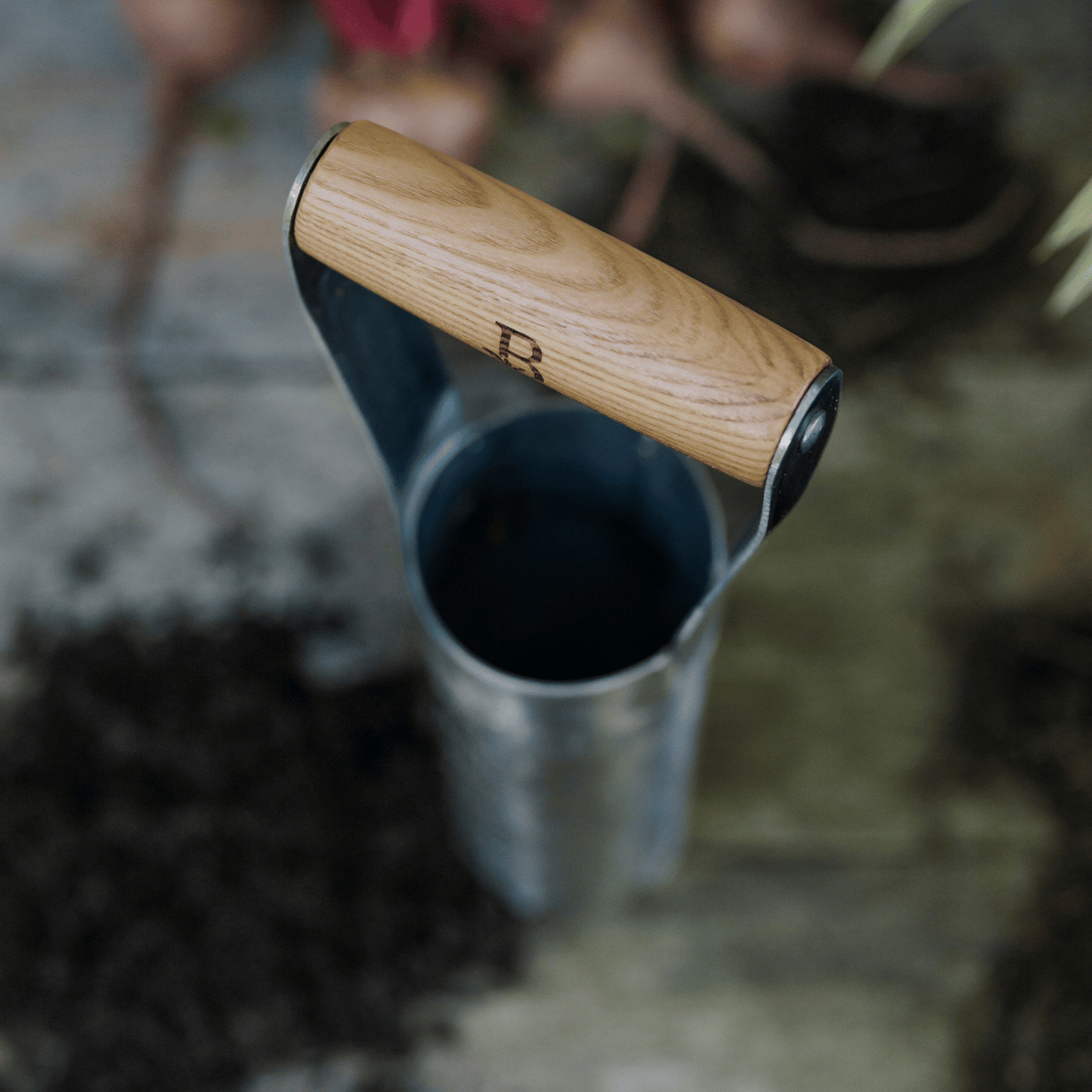 Ash wood handle with 'B' engraving on bulb planter.