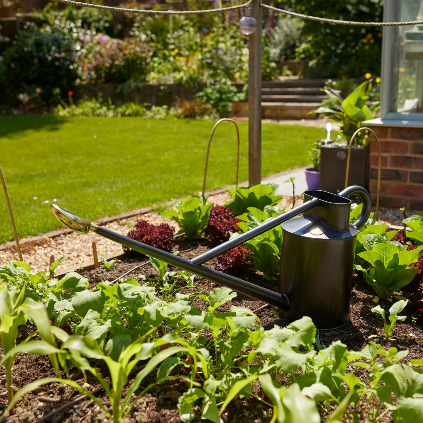 Haws Large Graphite Warley Fall Watering Can in Garden Bed