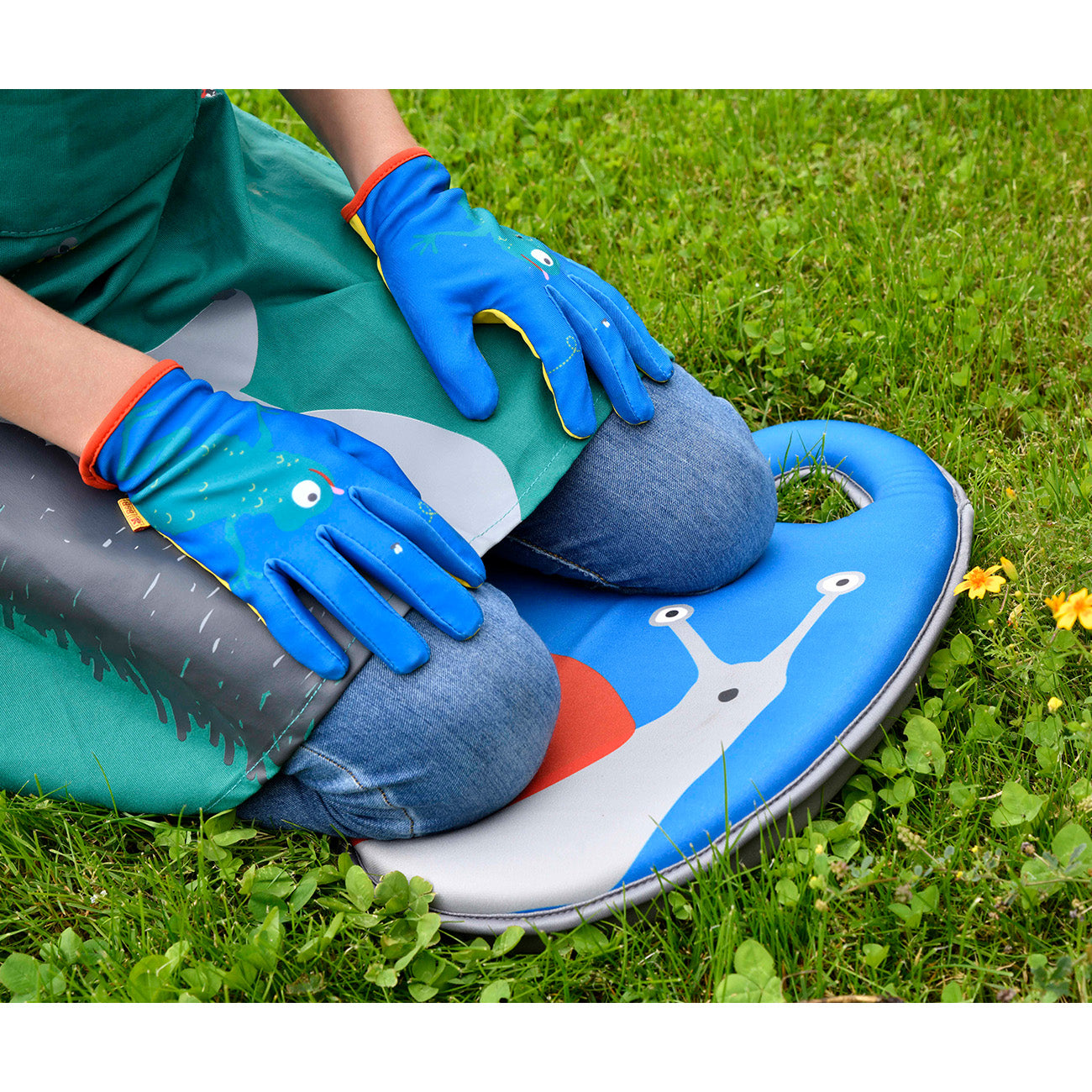 Child using garden kneeler with Burgon & Ball gloves and apron.