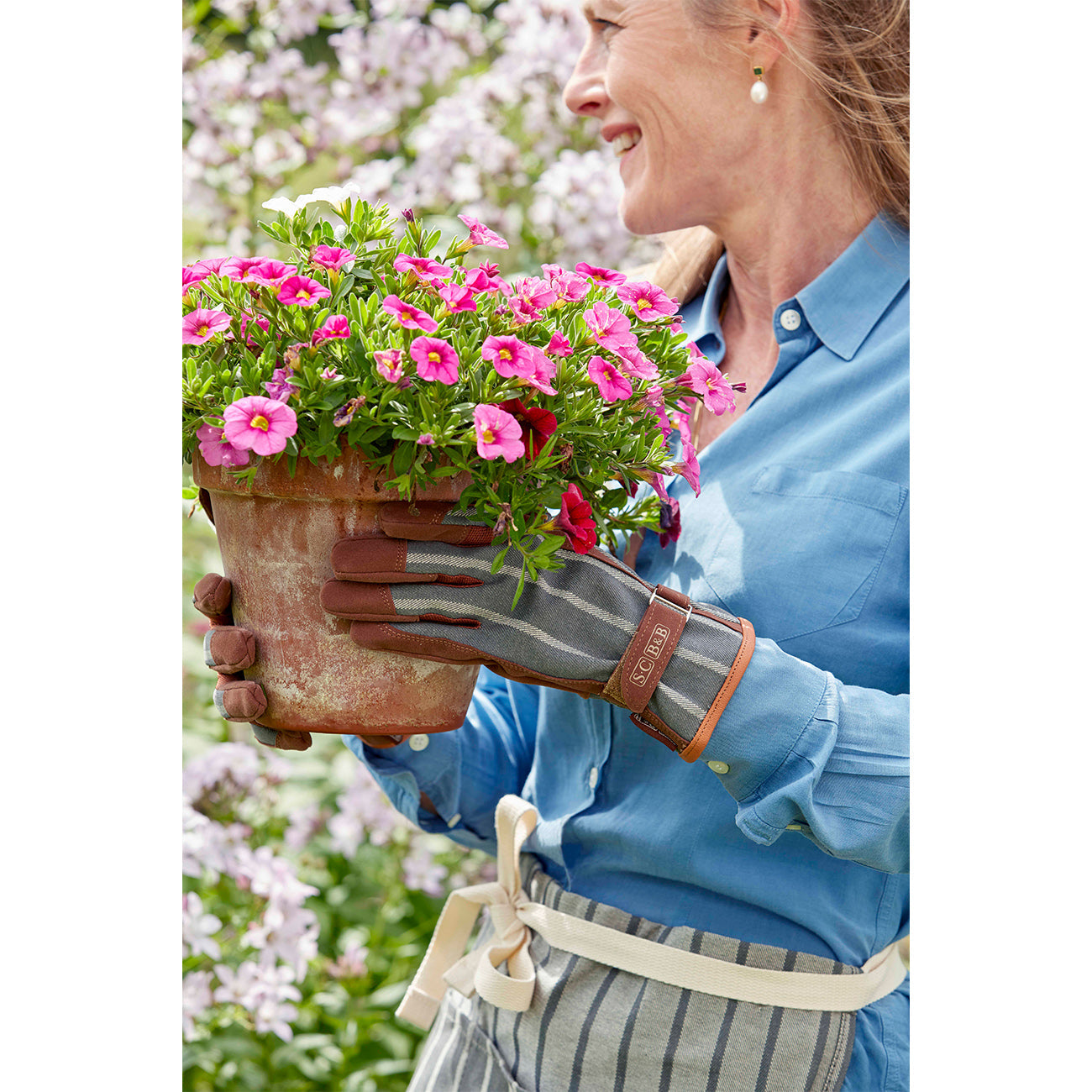 Sophie Conran wearing grey gardening gloves.