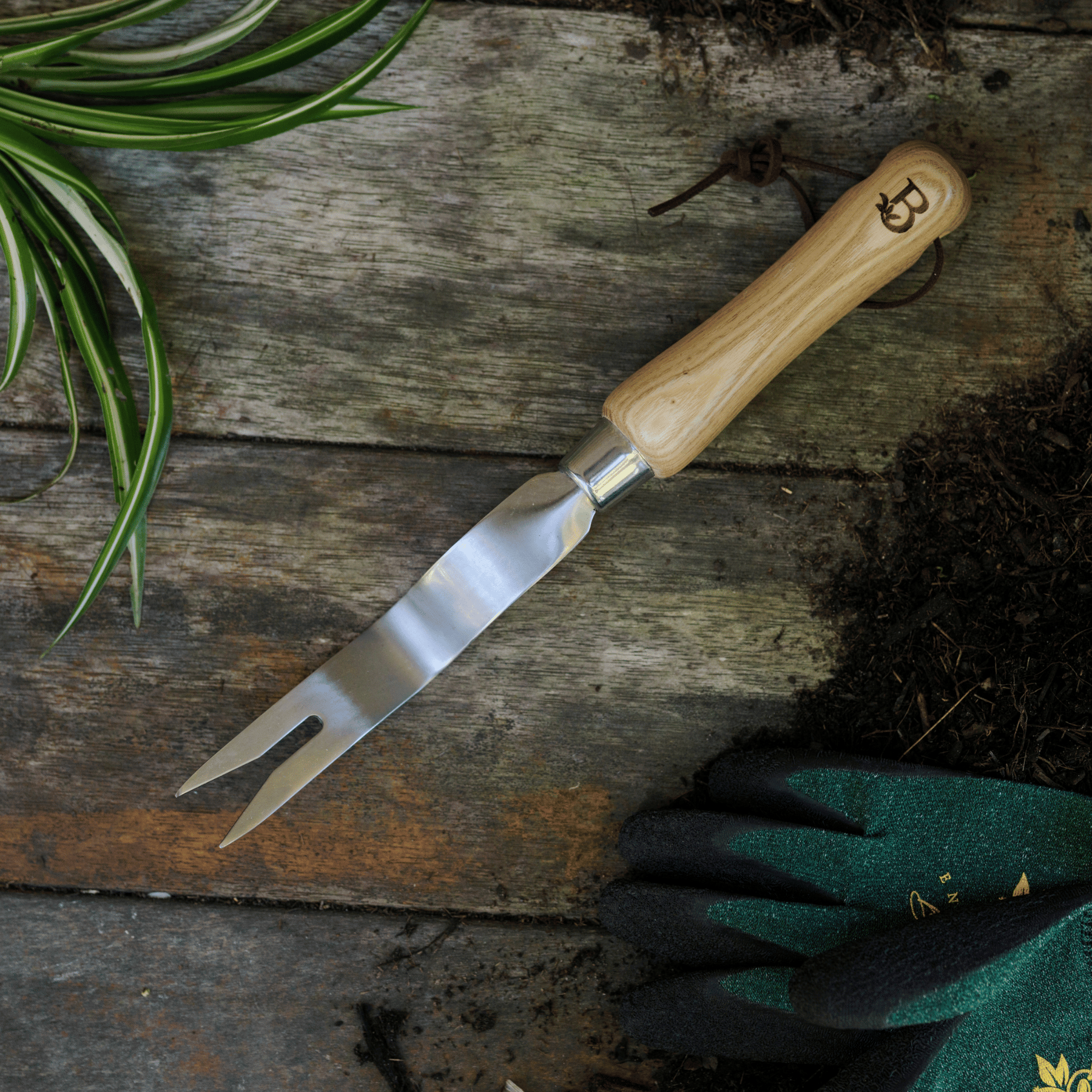 Dandelion weeding tool on potting bench.