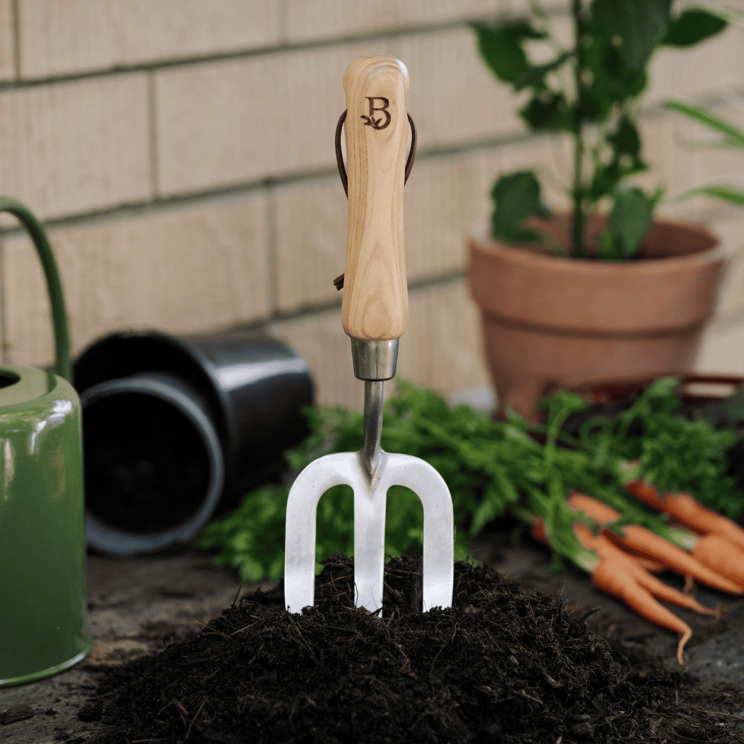 'Get Growing' Garden Hand Fork in mound of soil.