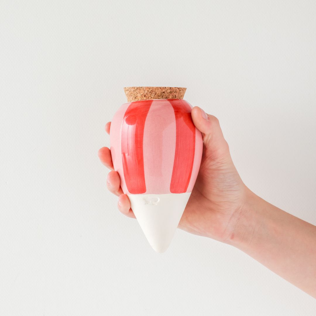 Hand holding pink & red striped Pepin Olla.