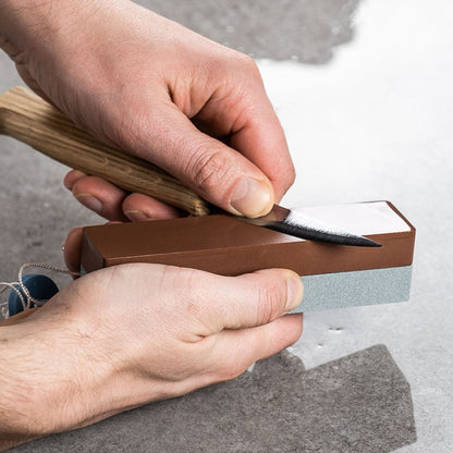 Person sharpening a blade on a King K40 Japanese combo whetstone.