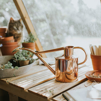 Haws Classic Copper Watering Can on Garden Bench